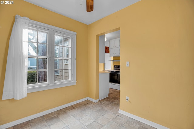 1175 Hines St SE, Salem, OR 97302 - unfurnished room with baseboards, a ceiling fan, and light stone finish flooring