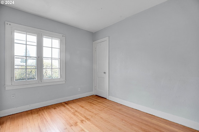 unfurnished room with light wood-type flooring