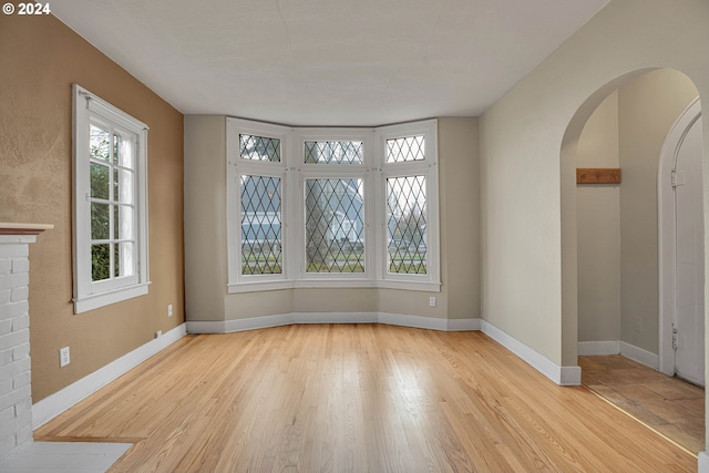 1175 Hines St SE, Salem, OR 97302 - unfurnished room featuring arched walkways, wood finished floors, and baseboards