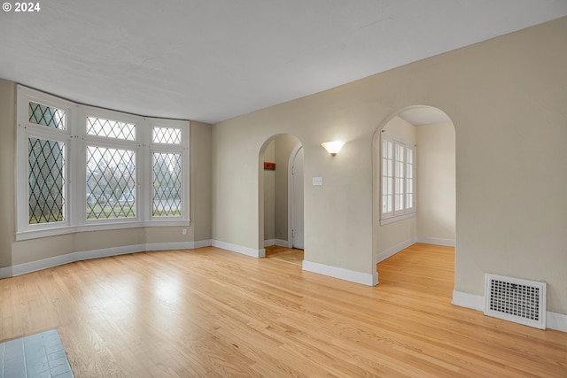 1175 Hines St SE, Salem, OR 97302 - spare room with arched walkways, wood finished floors, and baseboards