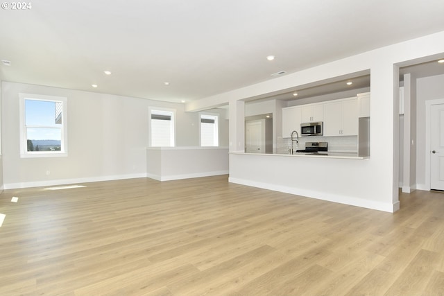 unfurnished living room featuring light wood-type flooring