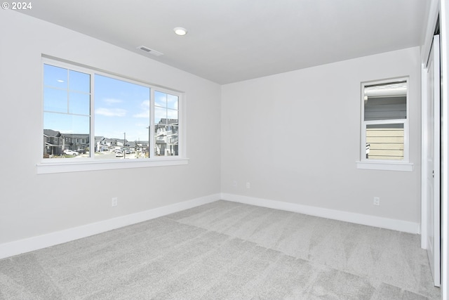 empty room featuring light carpet