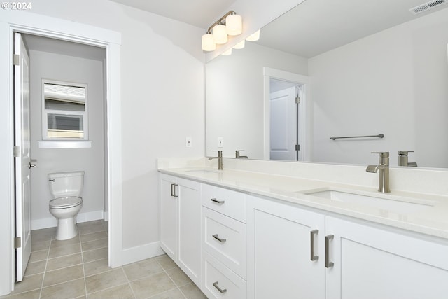 bathroom featuring tile patterned flooring, vanity, and toilet