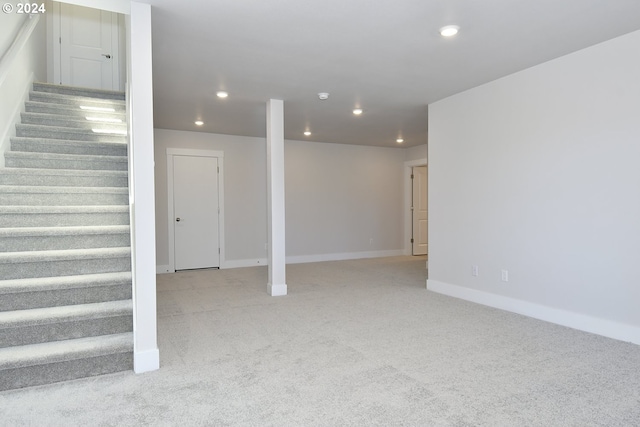 basement featuring light colored carpet