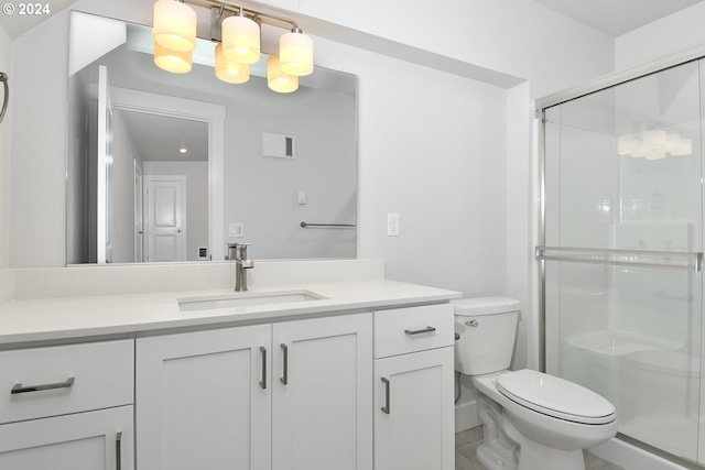 bathroom with vanity, an enclosed shower, and toilet