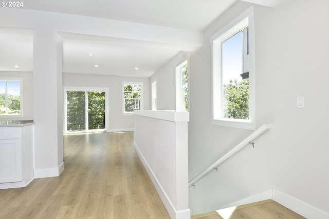 hallway with light hardwood / wood-style floors