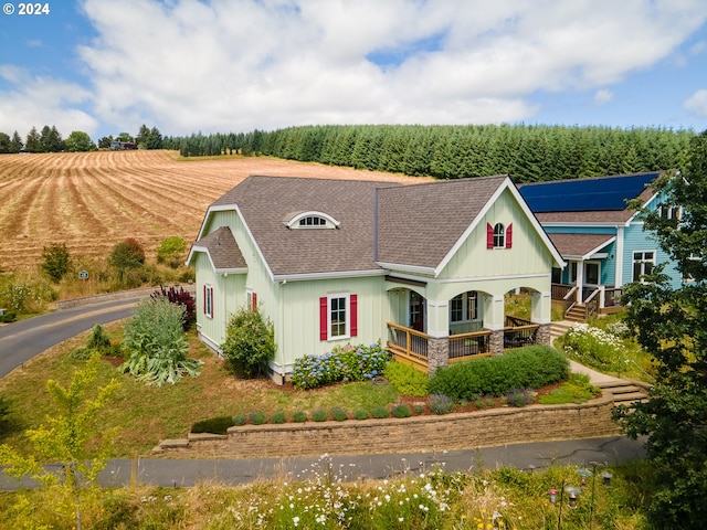 view of front of home featuring a rural view and covered porch