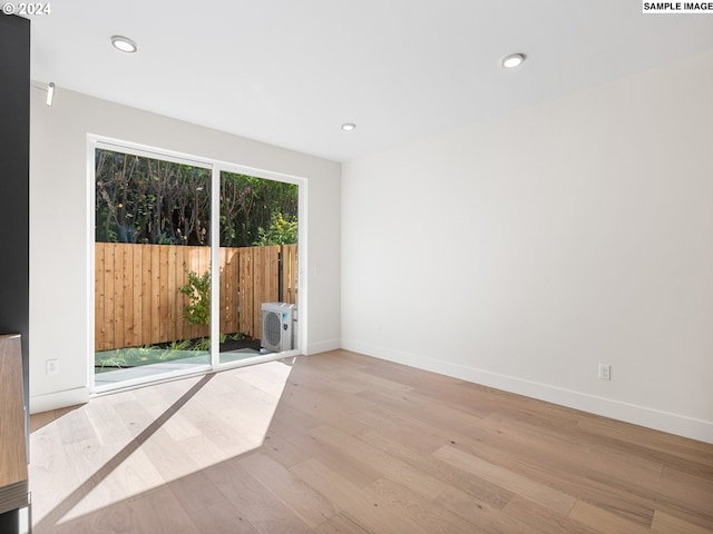 empty room with light hardwood / wood-style floors