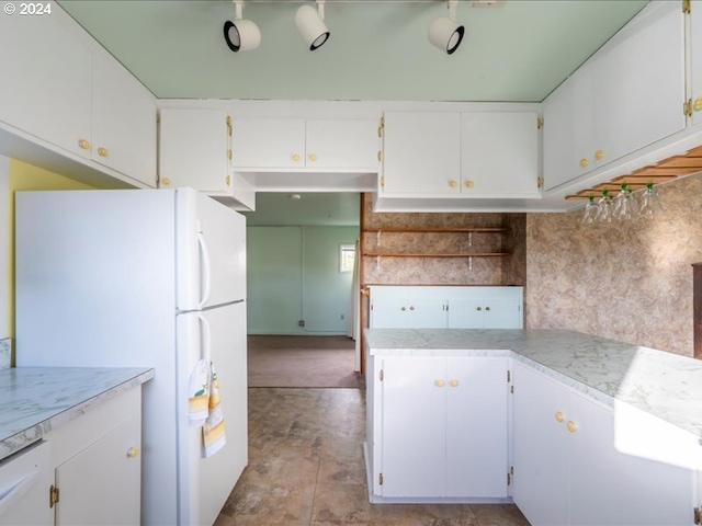 kitchen featuring decorative backsplash, white cabinets, and white appliances