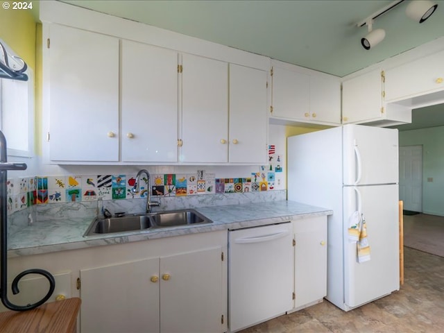 kitchen featuring white cabinetry, sink, and white appliances