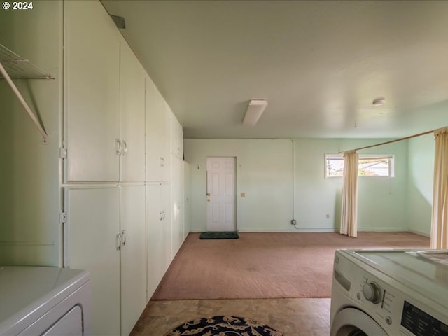 laundry room with cabinets, light carpet, and washing machine and dryer