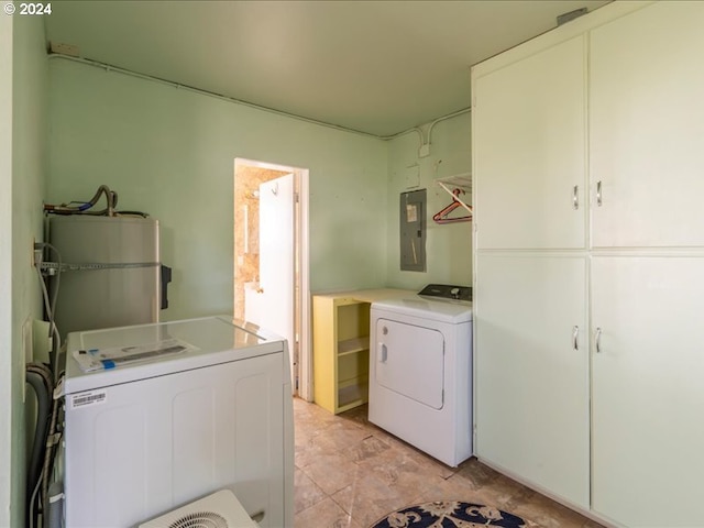 clothes washing area featuring cabinets, electric panel, washer and dryer, and water heater