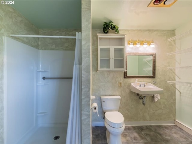 bathroom featuring toilet, sink, and walk in shower