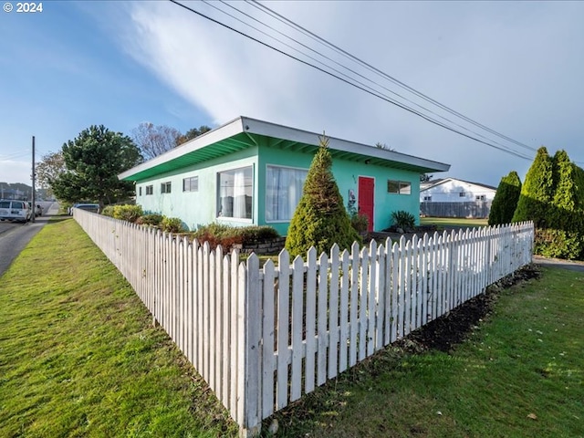 view of property exterior with a yard