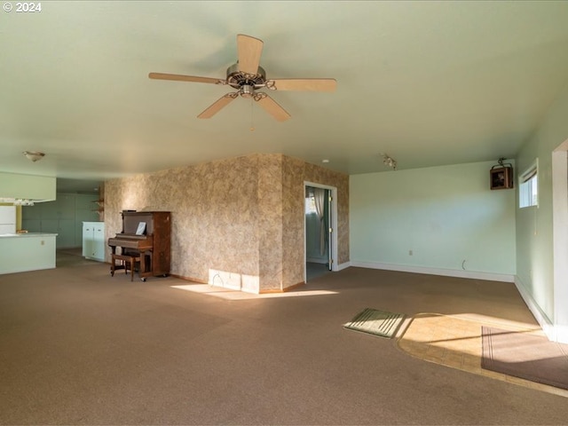 unfurnished living room featuring carpet and ceiling fan