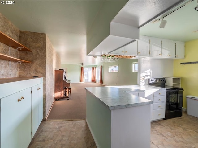 kitchen featuring white cabinets, kitchen peninsula, black / electric stove, and a healthy amount of sunlight