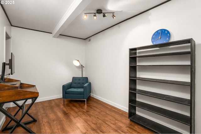 sitting room featuring beam ceiling and dark hardwood / wood-style floors