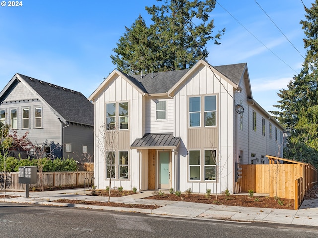 2519 NE Killingsworth St Unit 1, Portland, OR 97211 - view of front facade featuring board and batten siding, fence, a standing seam roof, roof with shingles, and metal roof