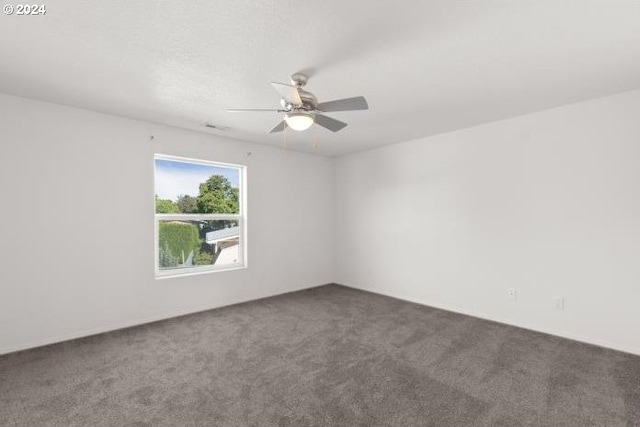 unfurnished room with ceiling fan and carpet floors