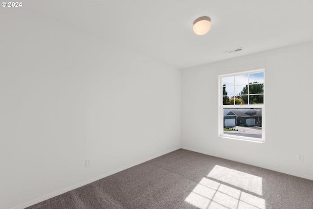 carpeted empty room with visible vents