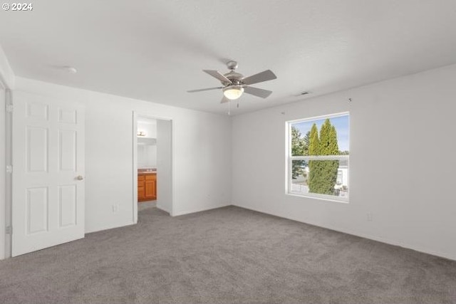 unfurnished bedroom featuring ceiling fan, carpet floors, and ensuite bathroom