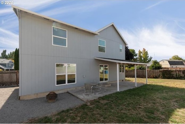 rear view of property with a patio area and a yard