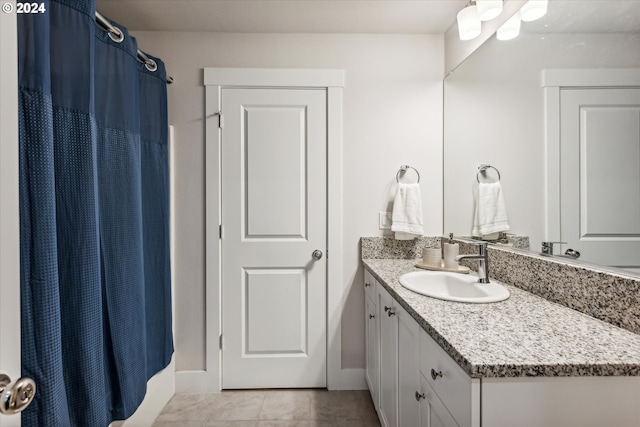 bathroom featuring tile patterned flooring and vanity