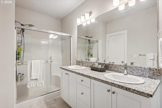 bathroom featuring vanity and a shower with door