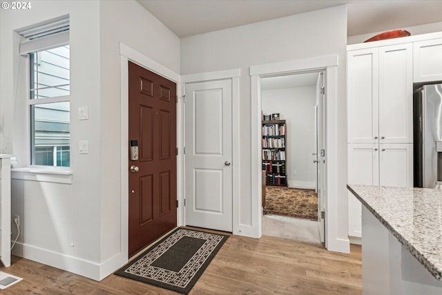 entryway with light hardwood / wood-style floors