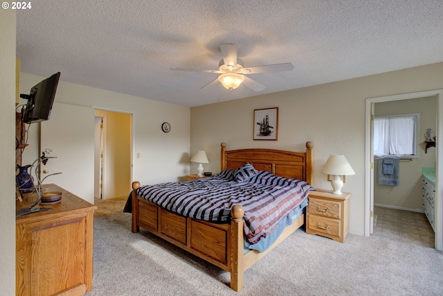 carpeted bedroom with ceiling fan and a textured ceiling