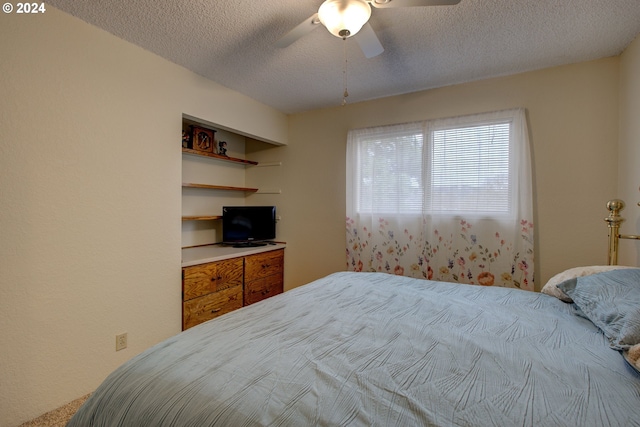 carpeted bedroom featuring a textured ceiling, a closet, and ceiling fan