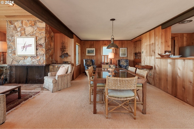 dining area with wooden walls and light colored carpet