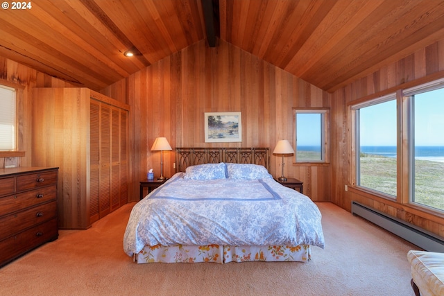 bedroom featuring light carpet, a closet, wood ceiling, and a water view