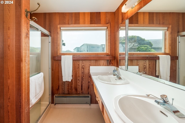 bathroom with vanity, a baseboard radiator, wooden walls, and an enclosed shower