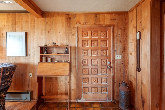 interior space featuring wooden walls and tile patterned floors