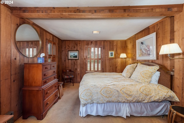 bedroom featuring light carpet and wood walls