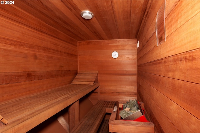 view of sauna with wood ceiling and wood walls