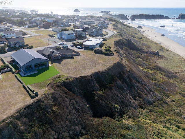 drone / aerial view featuring a water view and a beach view