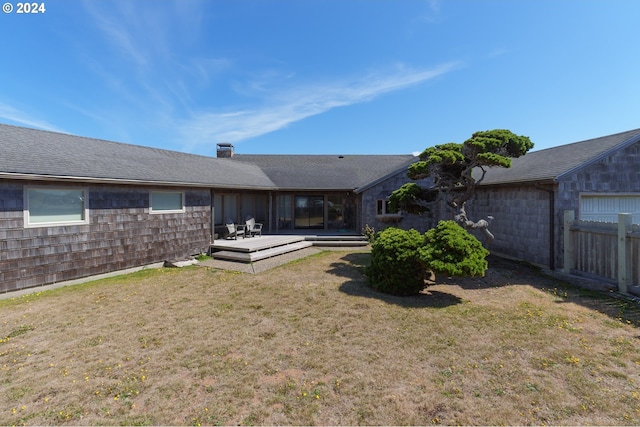 back of house with a yard and a deck