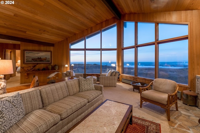 carpeted living room featuring a water view, wooden walls, wood ceiling, and vaulted ceiling with beams