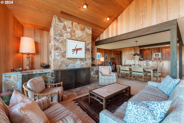 carpeted living room with wooden walls, high vaulted ceiling, and wooden ceiling