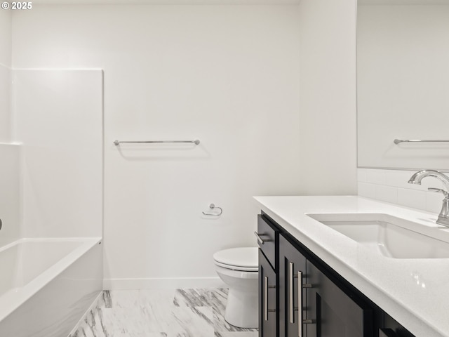 full bath featuring baseboards, toilet, marble finish floor, bathtub / shower combination, and vanity