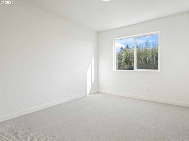 carpeted spare room with baseboards