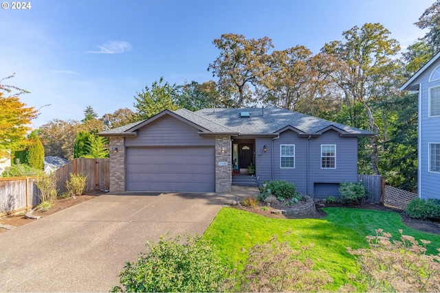 view of front of house featuring a garage and a front lawn