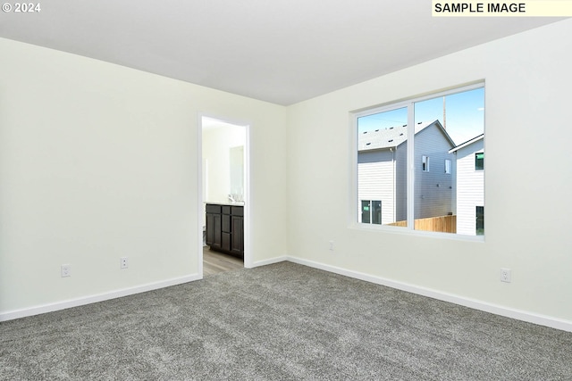 unfurnished room featuring light carpet