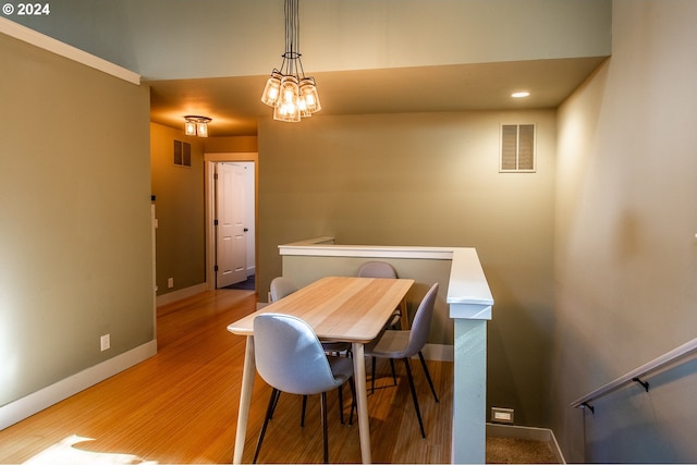 dining room featuring light hardwood / wood-style floors and an inviting chandelier