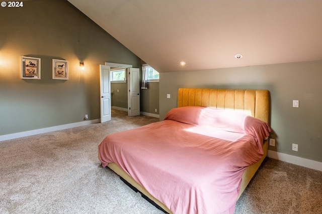 carpeted bedroom featuring vaulted ceiling