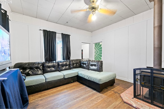 living room featuring ceiling fan and hardwood / wood-style floors