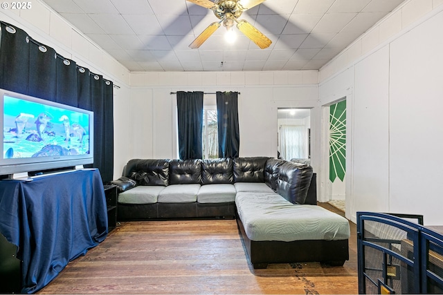 living room with ceiling fan and hardwood / wood-style floors