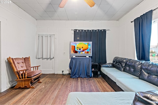 living room with hardwood / wood-style flooring and ceiling fan